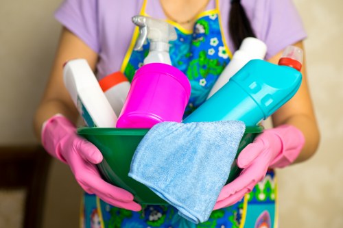 Cleaner handling carpet cleaning chemicals with protective gear
